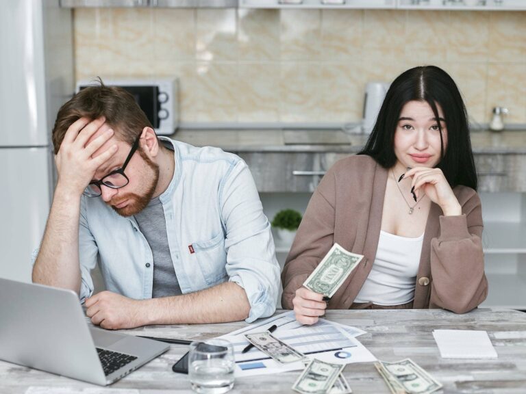 a couple calculating costs of a manufactured home