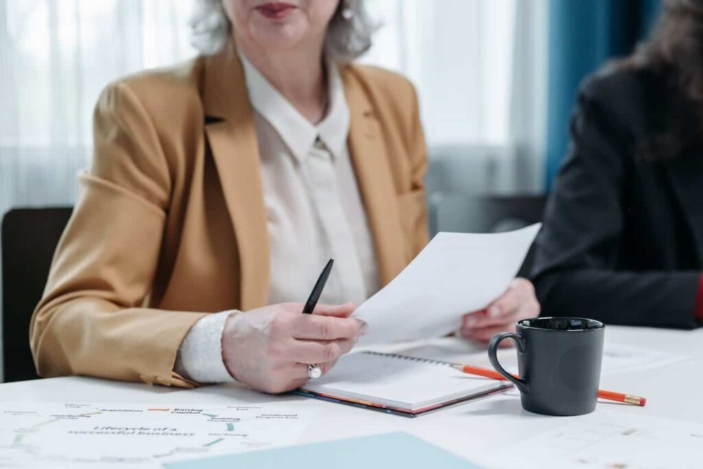 a woman holding construction loan paperwork