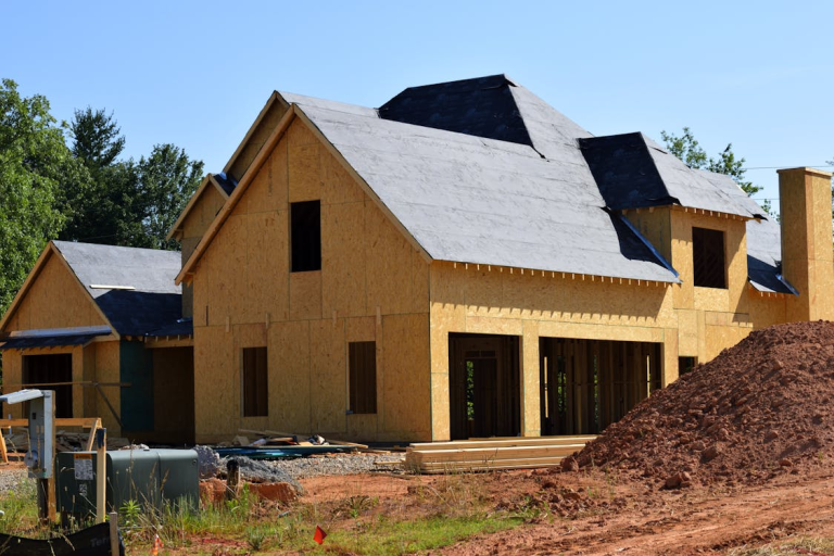 brown and gray wooden 2 storey house near tree