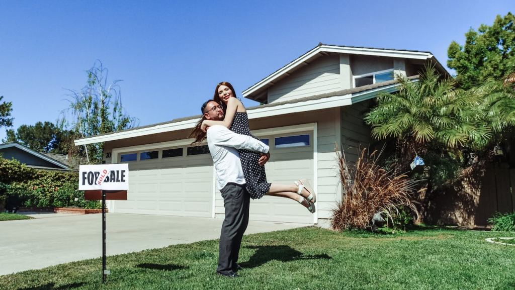 Man and Woman Showing the exterior of their house